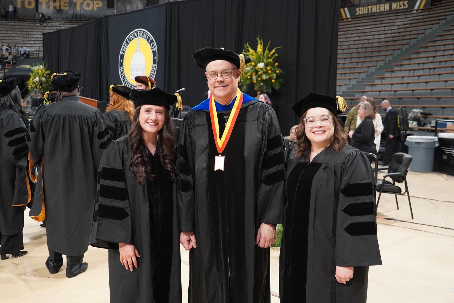 Drs. Alison Poor, Eric Dahlen, and Riley Davis at graduation
